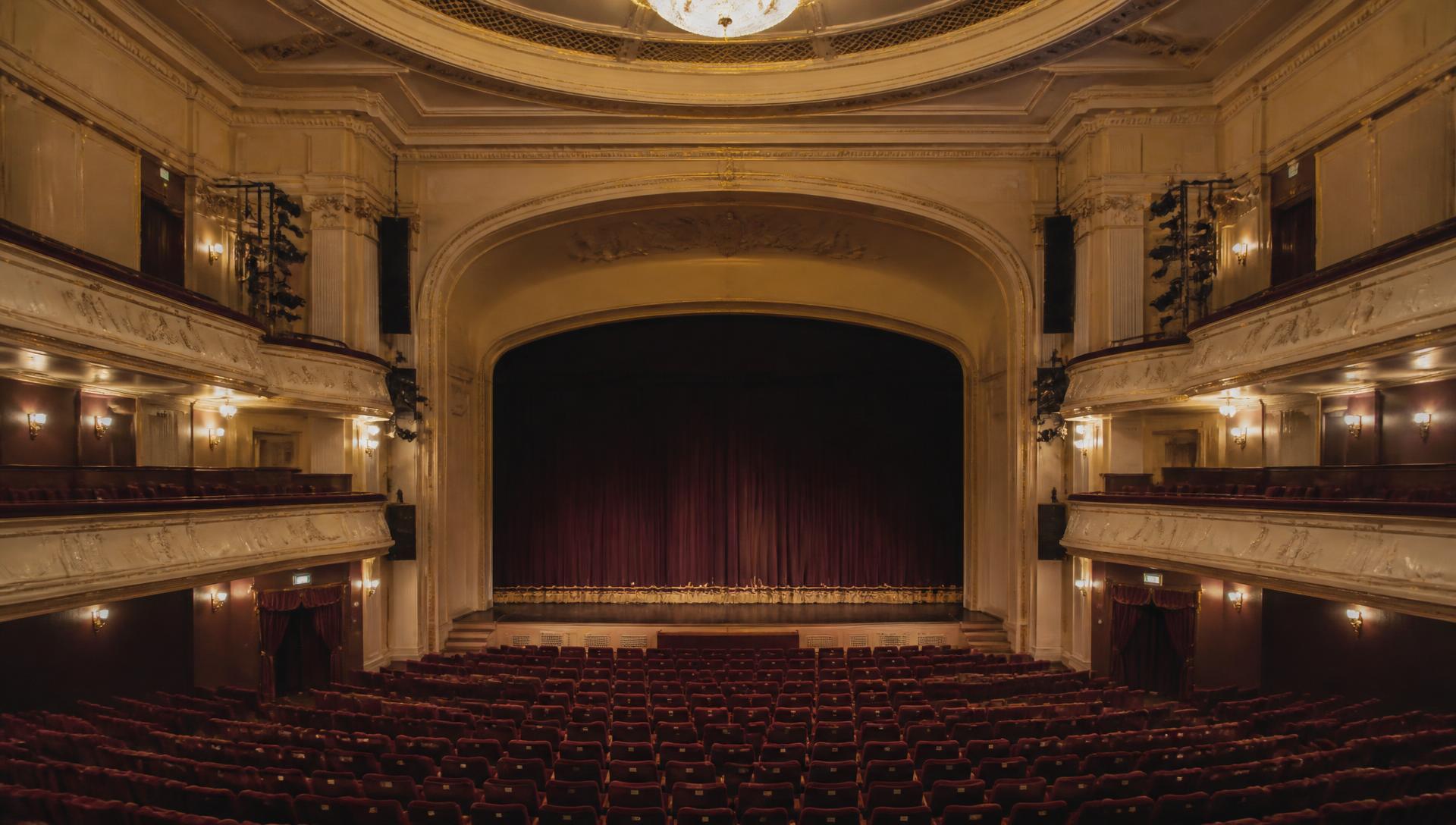 An empty theatre interior glowing in warm light before the performance